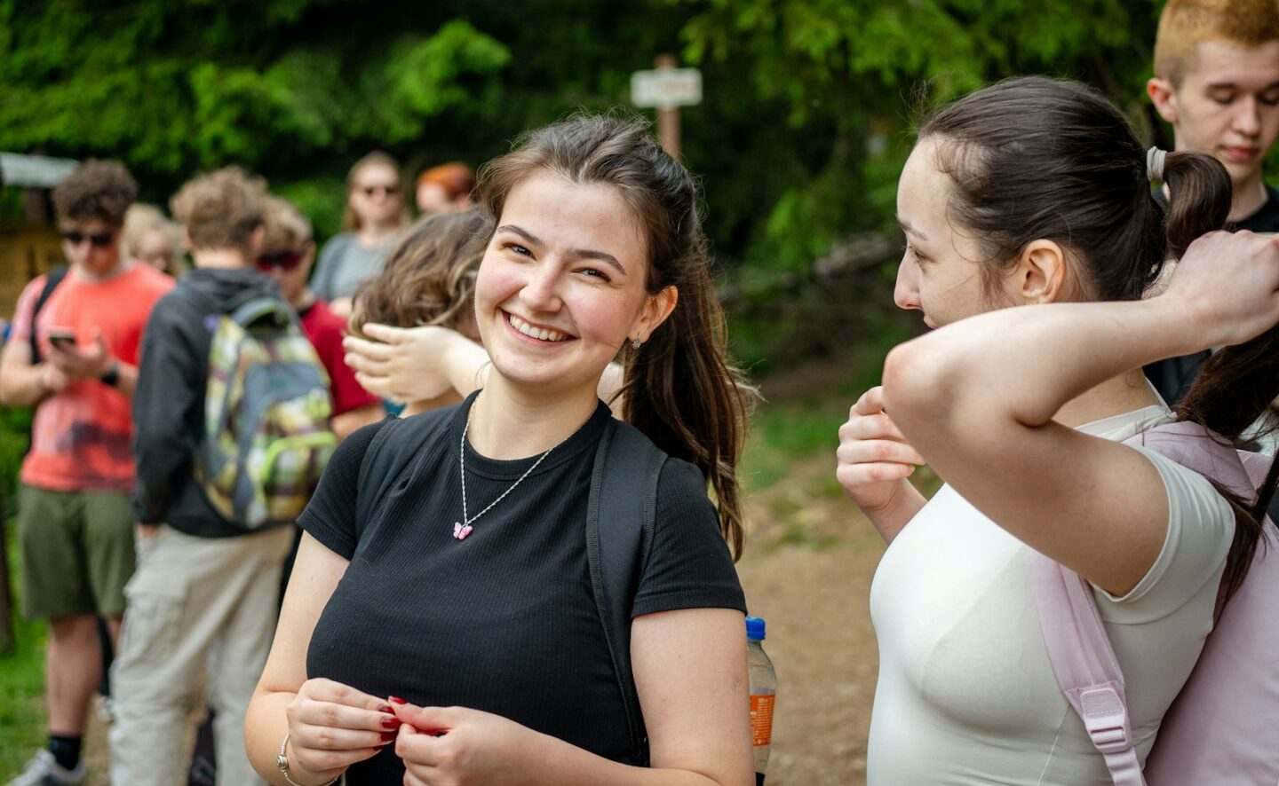 Teen girl laughing with friends on a hike, teen counseling at Common Thread Counseling